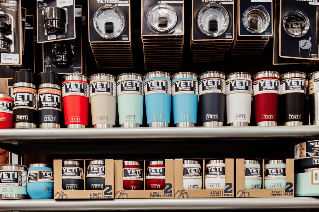 a photo of yeti mugs and accessories on a store shelf.