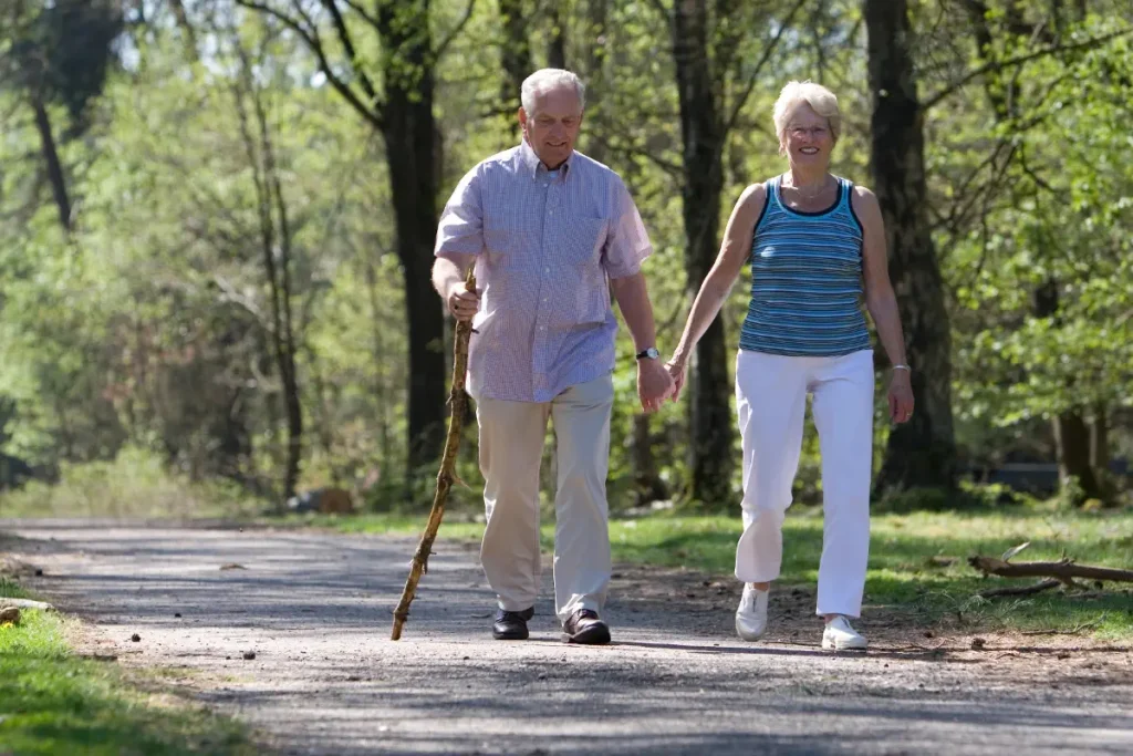 an older couple hiking in a park